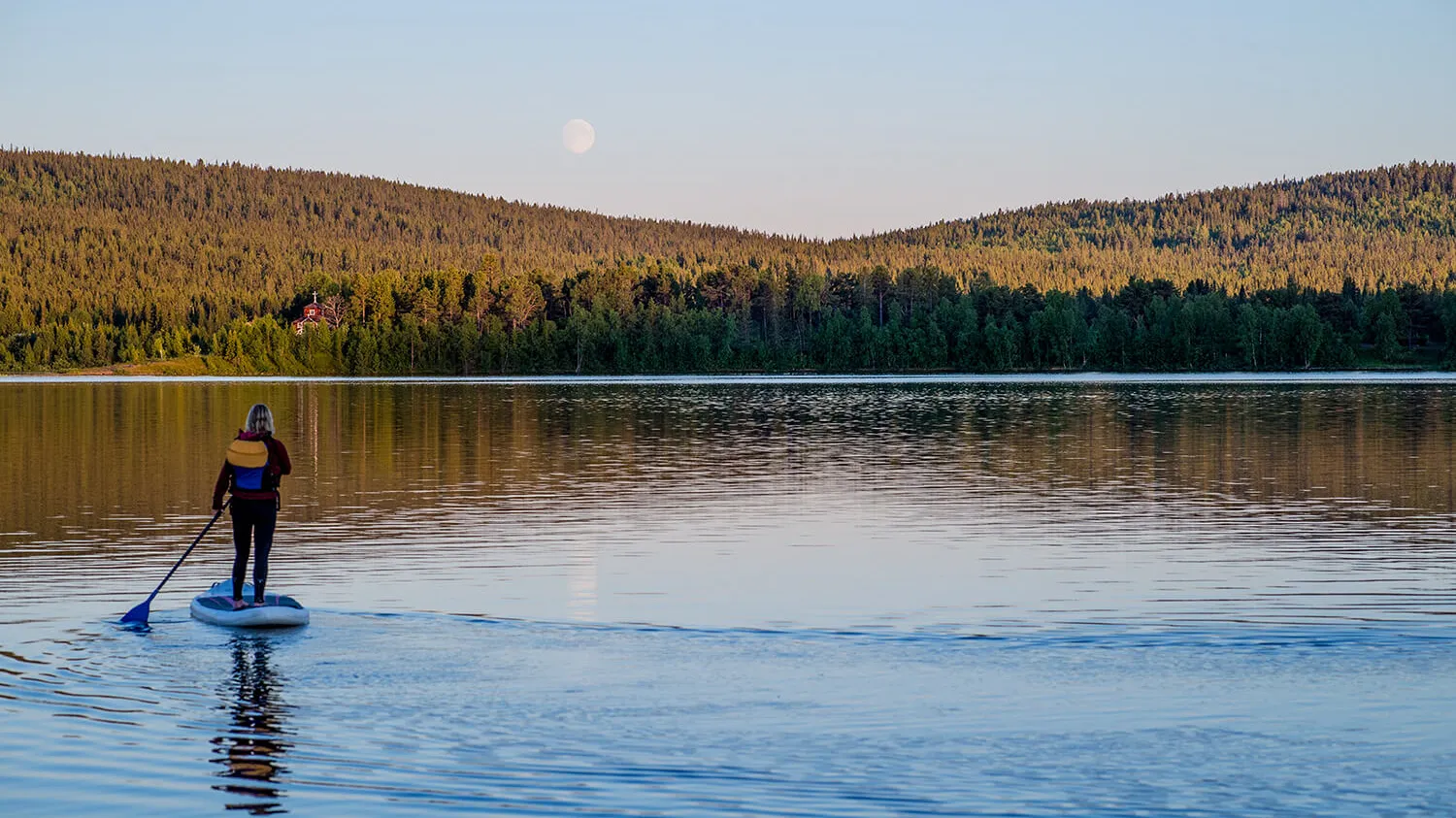 A man standning on a SUP in Torne River