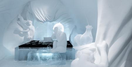 bed surrounded by animals made out of snow
