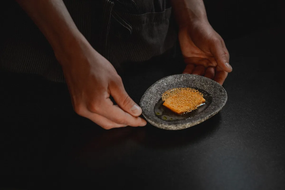 chef holding plate of food