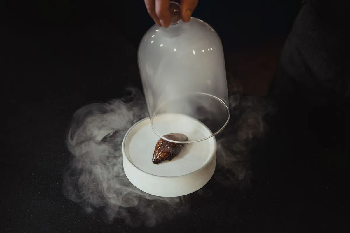 plate of food covered in smoke