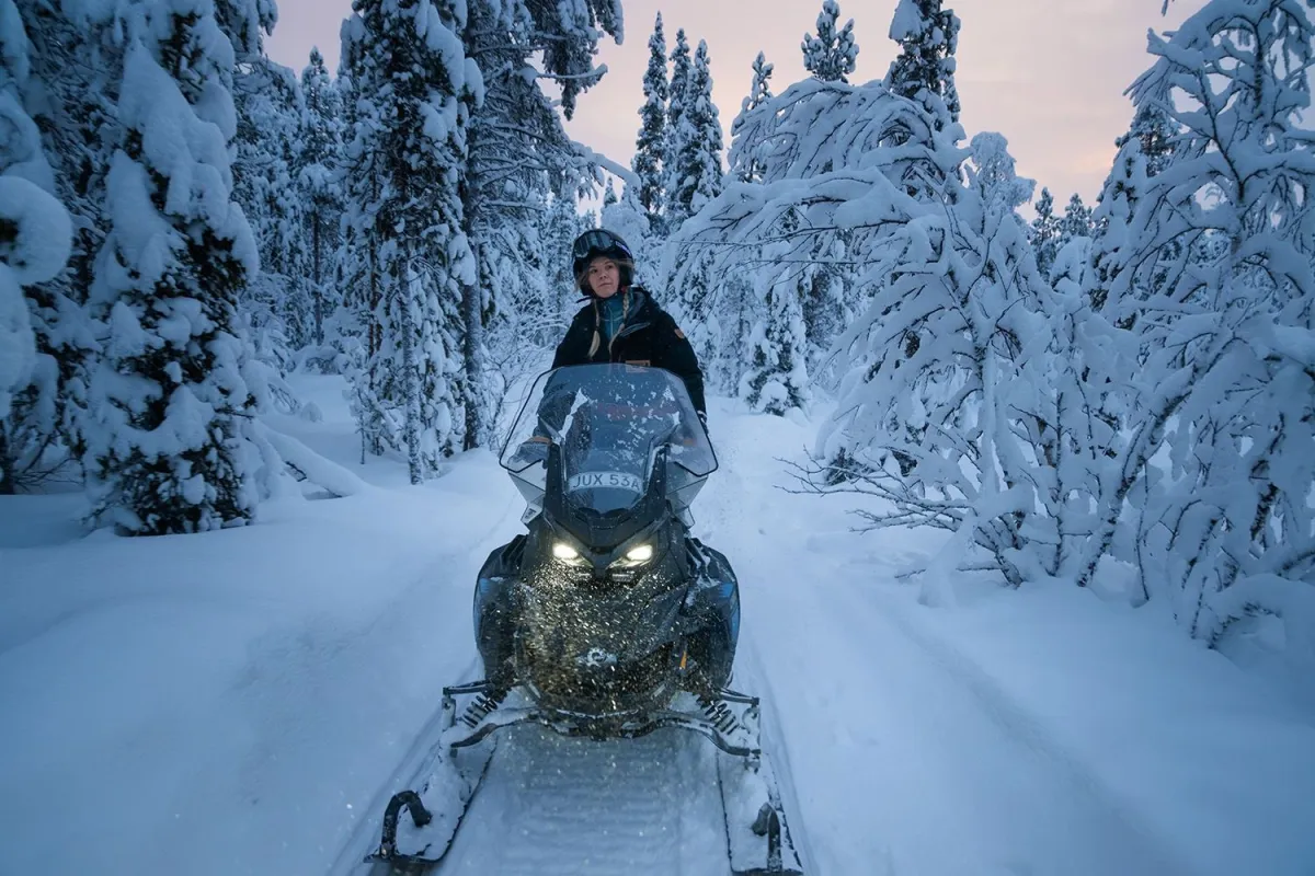 guide driving showmobile through the winder landscape