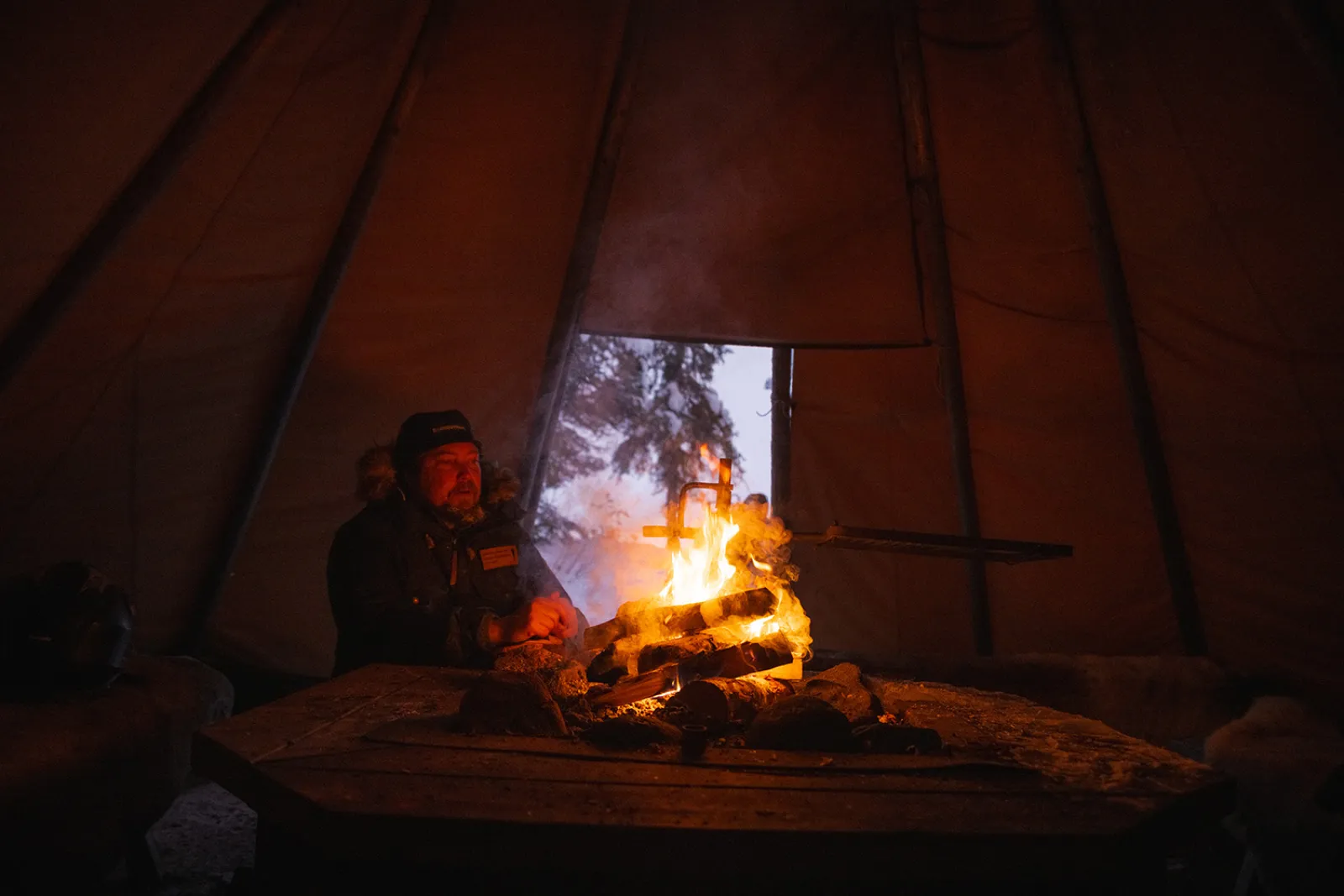 man in front of fire in a lavvu